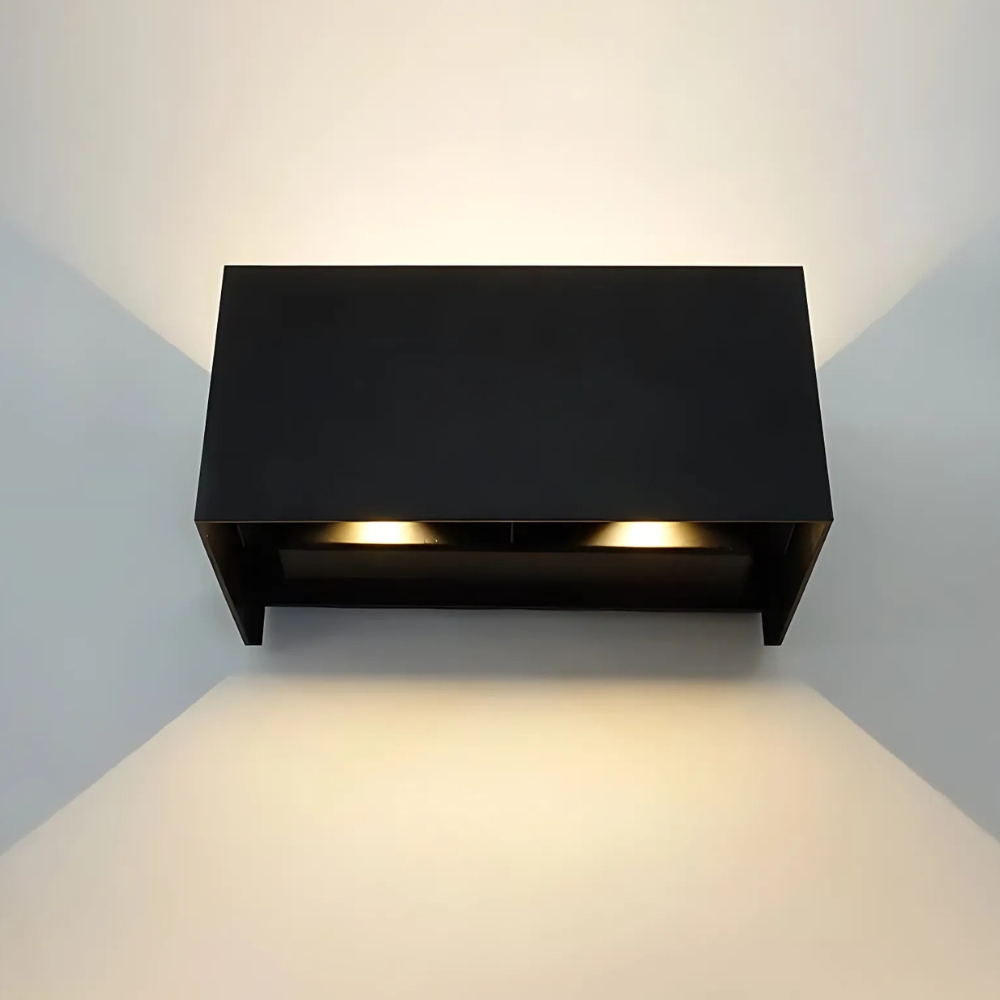 Schwarze rechteckige LED-Wandleuchte von vorne mit zwei warmen Lichtkegeln nach unten