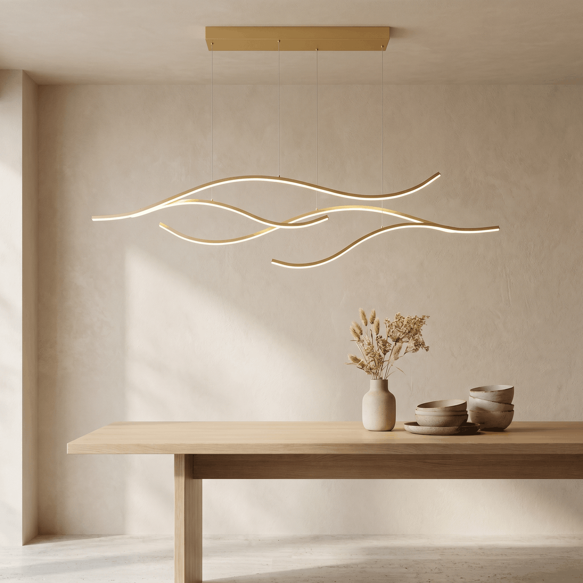Goldene LED-Hängeleuchte in Wellenform über einem hellen Holztisch